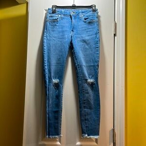 Woman’s Skinny Blue Denim Juliet Jeans with Frayed Bottom - Size 25